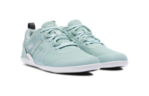 A pair of light blue Prio Women's athletic sneakers from Xero Shoes, featuring white soles and mesh uppers, is shown at a slight angle on a plain white background. The brand name 'Xero' appears on the tongue and side.